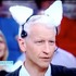 Anderson Cooper wearing a pair of robotic cat ears